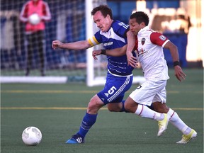 FC Edmonton's Albert Watson, left, seen battling the Ottawa Fury's Paulo Junior during a game earlier this season, says the Eddies want to go out Sunday at home and knock Ottawa off its perch.