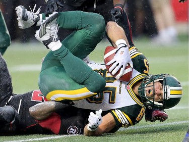 Edmonton's Nate Coehoorn grimaces in pain after being tackled by Jovon Johnson.
