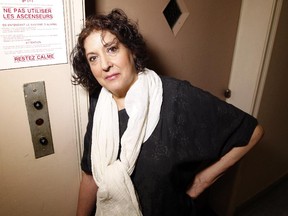 Esther Cleman stands beside the door to a the broken elevator in her apartment building at 255 Metcalfe St. on Tuesday.