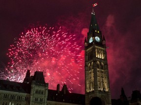 Fireworks explode behind the Peace Tower on Parliament Hill during Canada Day celebrations on Wednesday, July 1, 2015 in Ottawa.