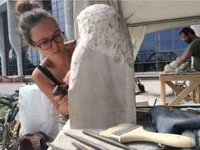Amy Ward of the United Kingdom chisels some stone during the Canadian Stone Carving Festival at the Museum of History on Saturday.