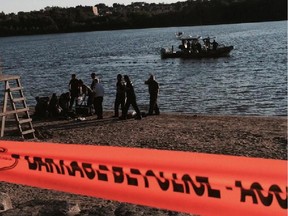 First responders tend to a 24-year-old man who was pulled from Lac Leamy by other beachgoers after he went missing Thursday evening. The man was taken to hospital in Gatineau. Police said his condition was unknown.