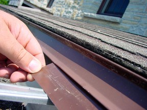 A waterproofing strip of factory-finished aluminum is installed under a rooftop drip edge. This strip overlaps the back of the trough, preventing water from leaking behind.