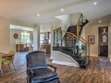 One of the home’s anchoring elements is a stunning wide-planked oiled maple floor, which offers a sharp yet pleasing contrast to the matte black painted staircase.