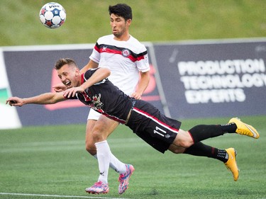 Fury player Oliver Minatel, left, dives for the ball as Kosuke Kimura defends.