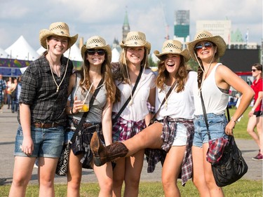 Girls from Brockville in cowboy hats and boots as day 2 of the RBC Ottawa Bluesfest features a country and western theme at the Canadian War Museum.  (L to R) Haleigh Baker, Hannah Duke, Emily Carkner, Brianna Healey and Rebecca Carr.