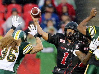 Henry Burris makes a pass with Aaron Grimes getting his hands up.