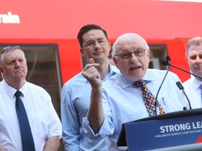 Member of Parliament for Ottawa-Orléans Royal Galipeau  announces new federal money for Ottawa's light rail development as Ottawa Councillor Bob Monette (L) and Regional Minister and Member of Parliament for Nepean-Carleton Pierre Poilievre (2nd from L) look on  , July 27, 2015.