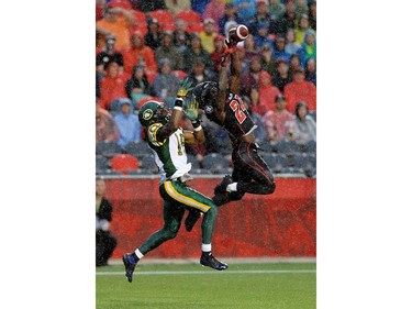 Ottawa Redblacks' Jerrell Gavins steals a catch from Edmonton Eskimos' Cory Watson to make a an interception in the Eskimos' end zone.