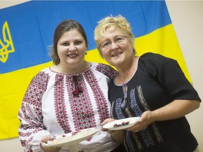 Jane Kolbe, left, and Mariyka Lachowich try Lachowich's delicious cherry-filled perogies in advance of the inaugural  Capital Ukrainian Festival being held in Ottawa from July 24-26.