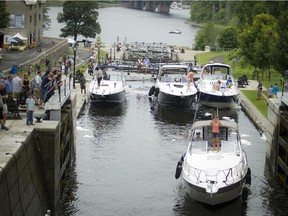 Large boats make their way through the Ottawa Locks at the Rideau Canal and the Ottawa River in July 2015.