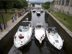 Large boats make their way through the Ottawa Locks at the Rideau Canal and the Ottawa River Saturday July 18, 2015. Some shoreline property owners are concerned about the impact boats are having on shoreline erosion on the Rideau River.
