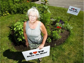 Marymay Downing stands in the garden outside her home on Ottawa's Shillington Drive, which she has tended for 20 years - and where a large community mailbox is slated to be placed soon.