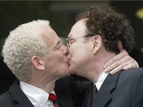 Michael Stark, left, and Michael Leshner kiss after their marriage in Superior Court in Toronto on Tuesday, June 10, 2003. Two years after an Ontario court ruling made same-sex marriage legal in Ontario, the Civil Marriage Act made it the law of Canada.