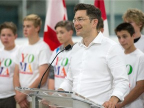 Pierre Poilievre, flanked by members of the Youth of Manotick Assoc., announced the federal government will inject $880,000 into the refurbishing of the Manotick Arena.