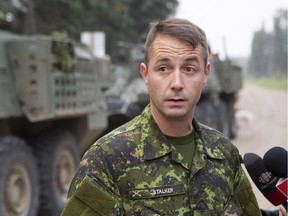 Lt. Col. Mason Stalker speaks with reporters as his troops aid in forest fire fighting  on Thursday, July 9, 2015.