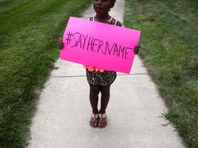 Daija Belcher, 5, holds a sign in front of the DuPage African Methodist Episcopal Church during the funeral service for Sandra Bland on July 25, 2015 in Lisle, Illinois.