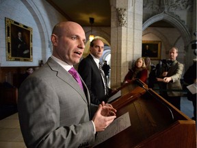 NDP Finance critic Nathan Cullen, left, and deputy critic Guy Caron hold a press conference in the Foyer of the House of Commons on Parliament Hill in Ottawa on January 26, 2015.