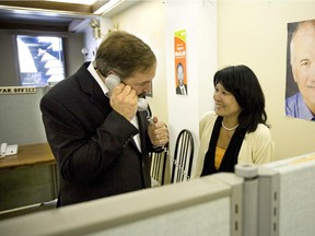 This 2007 photo shows then-NDP candidate for Outremont Tom Mulcair speaking to voters on the phone as Olivia Chow , wife of then-NDP NDP leader Jack Layton, does some last minute campaigning with him.