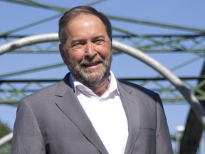 NDP leader Tom Mulcair poses for a photo on the Blackfriars Bridge during a stop in London, Ont. on Friday July 24, 2015.