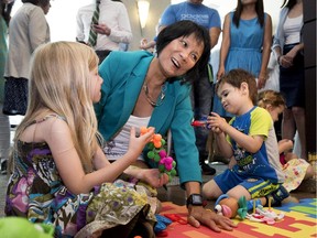 Olivia Chow, centre, plays with children following a press conference where she announced her return to federal politics in Toronto on Tuesday, July 28, 2015.