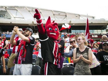 Ottawa Fury FC mascot Sparky cheers with fans before the start of the team's game against the Carolina RailHawks in Ottawa, July 26, 2015.