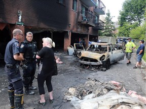 Ottawa police investigate a garage fire that destroyed a car at 1042 Merivale Rd. near Shillington Ave. in Ottawa, Wednesday, July 8, 2015.