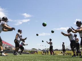 Ottawa Redblacks' offensive linemen run a drill during practice.