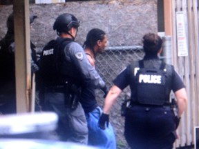 Man is taken into custody at the crime scene at shooting near Lilas Private in Overbrook Tuesday.