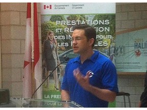 Pierre Poilievre's decision to wear a Conservative Party golf shirt during an announcement Monday, July 20, 2015 on child care benefits payments is being criticized by the opposition.
