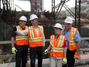 Yukon Premier Darrell Pasloski, Newfoundland and Labrador Premier Paul Davis, Ontario Premier Kathleen Wynne and Northwest Territories Premier Bob McLeod, left to right, tour the construction site of the hydroelectric facility at Muskrat Falls, Newfoundland and Labrador on Tuesday, July 14, 2015. The project includes the construction of an 824 megawatt hydroelectric dam on the lower Churchill River in Labrador.