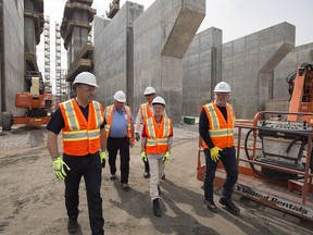Yukon Premier Darrell Pasloski, Northwest Territories Premier Bob McLeod, Newfoundland and Labrador Premier Paul Davis, Ontario Premier Kathleen Wynne and Nalcor CEO Ed Martin, left to right, tour the construction site of the hydroelectric facility at Muskrat Falls, Newfoundland and Labrador, before a premiers' meeting where they agreed on a new pan-Canadian energy strategy.