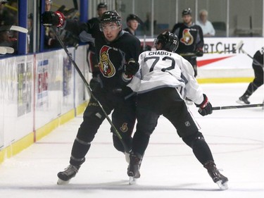 Prospects Nick Paul #13 tries to skate past Thomas Chabot #72 of the Ottawa Senators during a scrimmage at the Kanata Recreation Centre in Ottawa on July 2, 2015.