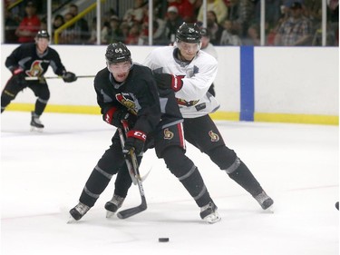 Prospects Shane Eiserman #64 battles for the puck against Filip Ahl #76 of the Ottawa Senators during a scrimmage at the Kanata Recreation Centre in Ottawa on July 2, 2015.
