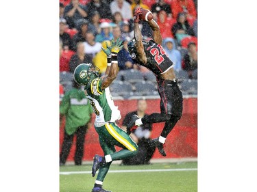 Redblacks #24 Jerrell Gavins, right, makes an interception on Cory Watson.