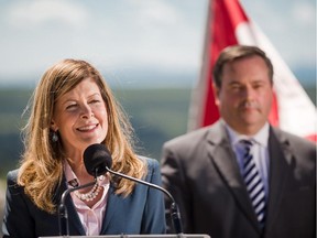 Joan Crockatt, MP for Calgary Centre, introduces Jason Kenney, Minister of National Defence, Minister for Multiculturalism and MP for Calgary Southeast, as he speaks to the media about Federal money being provided for the next leg of Calgary's ring road, at Battalion Park in Calgary on Thursday, July 30, 2015.