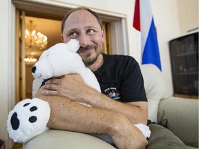 Sergey Ananov holds a stuffed polar bear toy in recognition of the three bears he says he encountered on the Arctic ice.