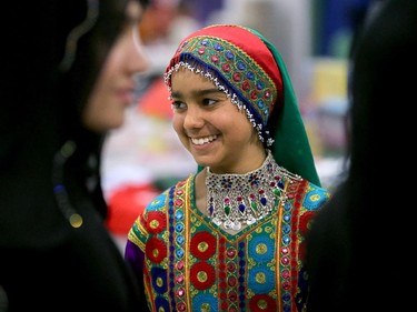 Shabana Rahmati, 12, was a vision in traditional jewels and clothes as she made her way through the festival with her older sisters (left and right) and family at the EY Centre, July 17, 2015.
