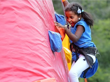 Six-year-old Shaima Sirag had a hoot climbing her way to the top of the inflatable rock-climbing wall at the EY Centre Eid al-Fitr and Muslim Summer Festival celebrations, July 17, 2015.
