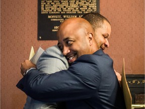 State Reps. John King (L) and Cezar McKnight celebrate after the House approved a senate bill to remove the Confederate battle flag from the South Carolina capitol grounds July 9, 2015 in Columbia, South Carolina. Lawmakers debated for more than 13 hours before approving the bill early Thursday morning.