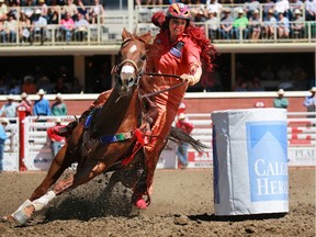 Fallon Taylor from Collinsville Texas competes in the barrel racing event during the Calgary Stampede. She is the wife of Ottawa Redblacks kicker Delbert Alvarado.