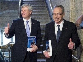 Prime Minister Stephen Harper (left) stands with Finance Minister Joe Oliver as he arrives to table the budget on Parliament Hill in Ottawa on Tuesday, April 21, 2015.