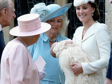 Catherine, Duchess of Cambridge holding Princess Charlotte of Cambridge talk to Queen Elizabeth II and Camilla, Duchess of Cornwall at the Church of St Mary Magdalene on the Sandringham Estate after the Christening of Princess Charlotte of Cambridge on July 5, 2015 in King's Lynn, England.