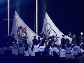 The Pan American and Olympic flags are raised during the opening ceremony of the 2015 Pan American Games in Toronto on Friday, July 10, 2015.