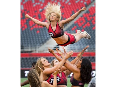 The Redblacks Cheer Team is out early to practice.