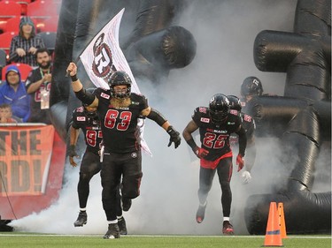 The Redblacks take the field led by offensive lineman #63 Jon Gott.