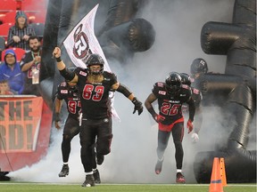 Offensive lineman Jon Gott leads the Redblacks onto the TD Place field on Friday, July 17, 2015.