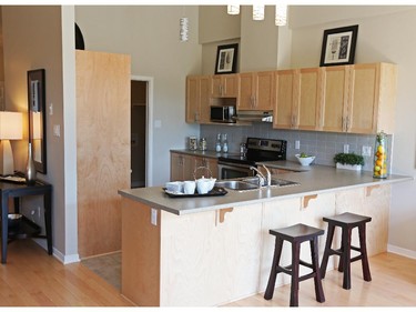 The kitchen includes a breakfast bar and upgraded, Shaker-style cabinets.