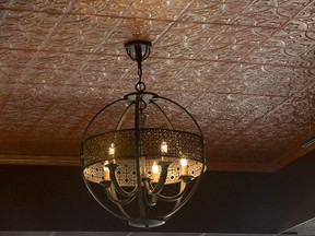 Distressed tin panels on the ceiling bring Old World charm to a home.