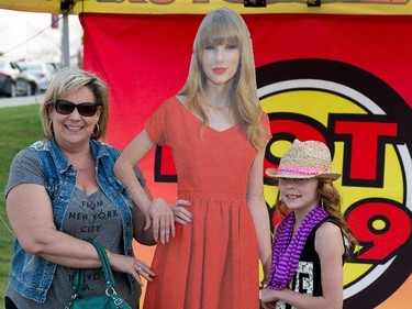 Valerie Seeley and her daughter Arianna pose with a cutout of Taylor Swift.